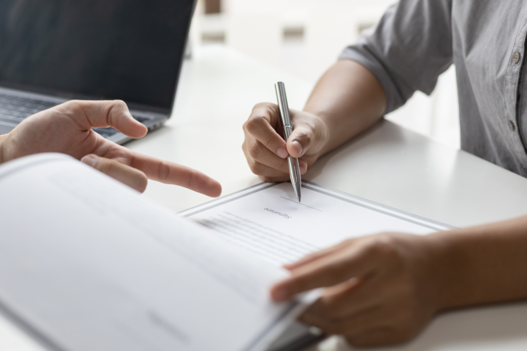 Two people discussing leasing management at an office table